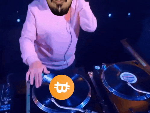 a man with a beard is playing a record on a turntable with a coin with the letter b on it