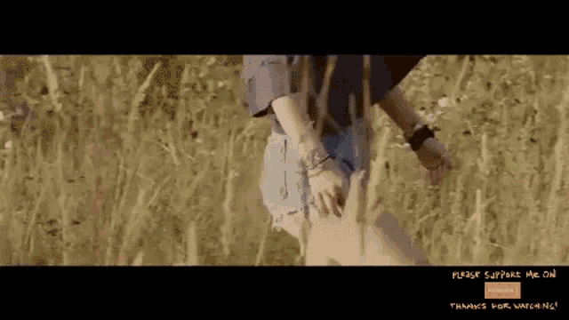 a woman walking through a field with the words please support me on thanks for watching on the bottom