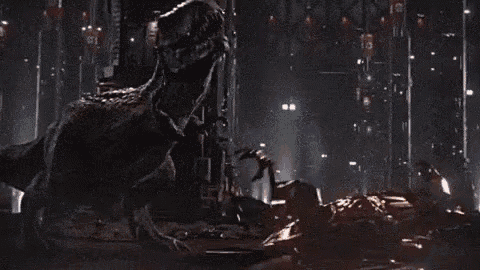 a dinosaur is fighting a robot in a dark room in a video game .