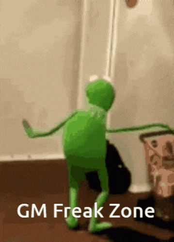 a kermit the frog is dancing in a room with the words gm freak zone below him