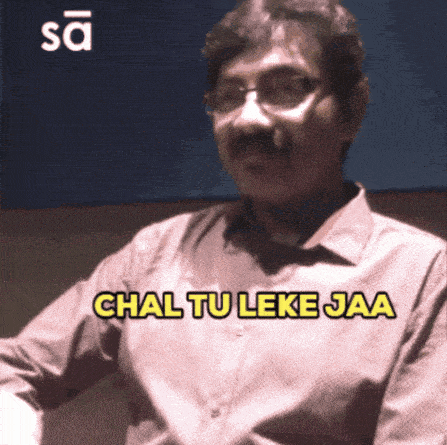 a man with glasses and a mustache says " chal tu leke jaa "
