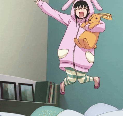 a girl in a bunny costume is jumping in the air holding a stuffed rabbit