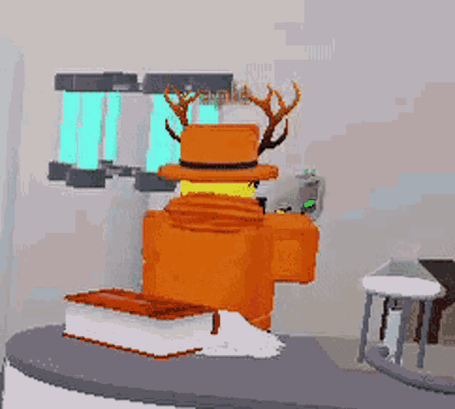 a cartoon character with antlers is standing next to a book on a table .