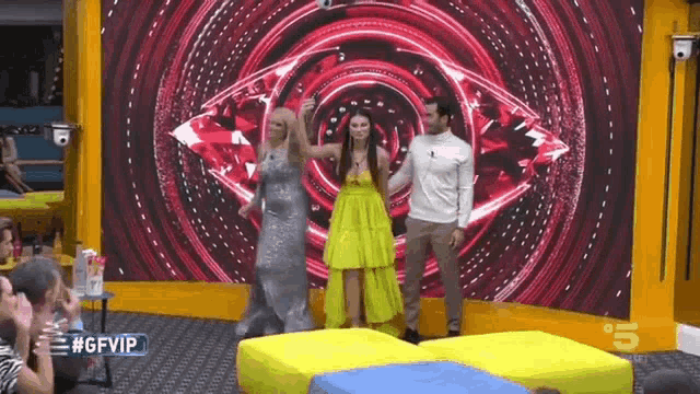 a group of people are standing in front of a large screen that says gfvip on it .