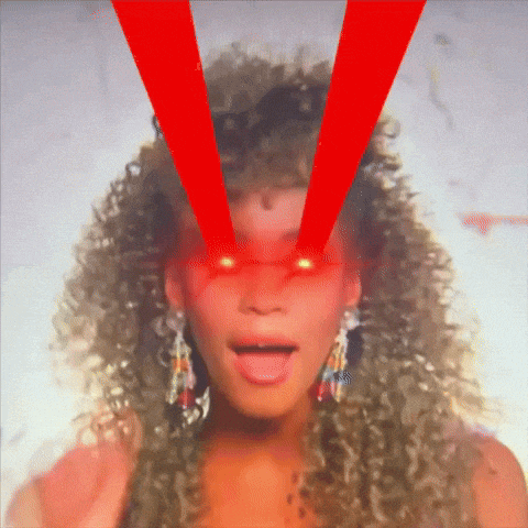 a woman with curly hair has red light coming out of her eyes