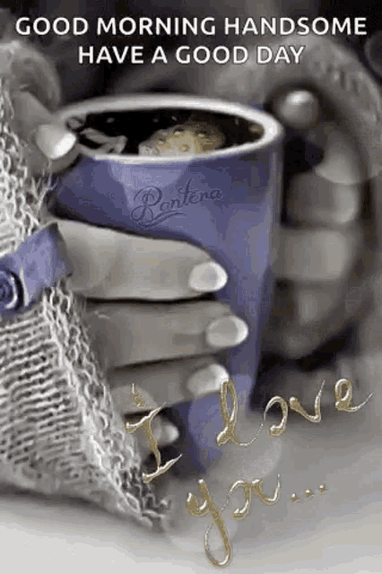 a woman is holding a cup of coffee in her hands .