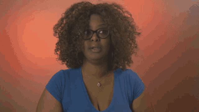 a woman wearing glasses and a blue shirt has the word gross on her chest
