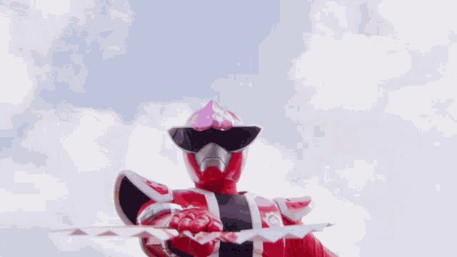 a blurred image of a person in a red costume holding a flag