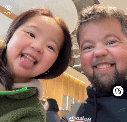 a little girl sticking her tongue out next to a man in a balenciaga sweatshirt