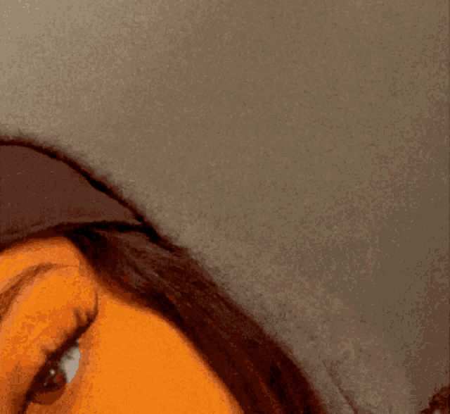 a close up of a woman 's face wearing a hoodie
