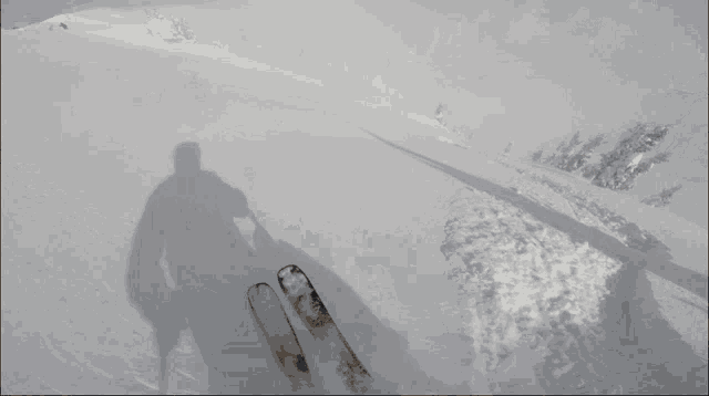 a person wearing a pair of gloves is pointing at something