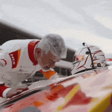 a man in a race car uniform with the word rex on it