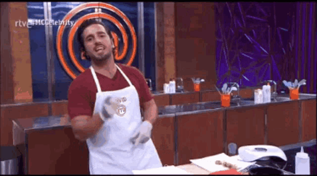 a man in an apron is dancing in front of a master chef logo