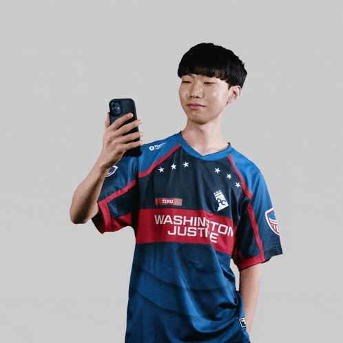 a man wearing a washington justice jersey takes a selfie