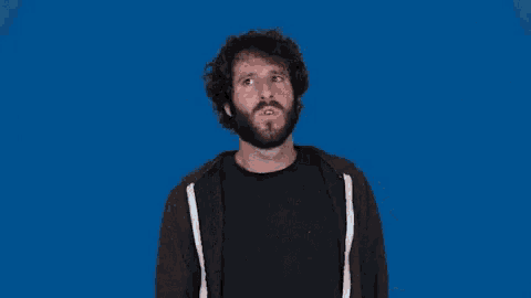 a man with a beard is making a stop sign in front of a blue background that says no on it