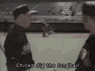 two men are standing on a baseball field talking to each other and one of them is saying `` chicks dig the longball '' .