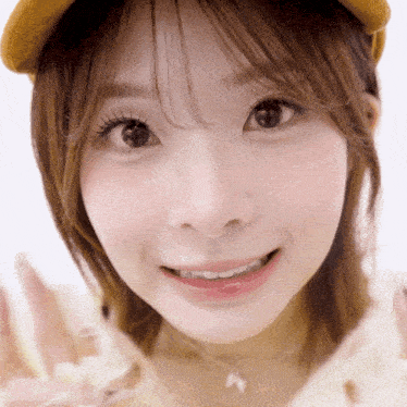 a close up of a woman 's face wearing a hat