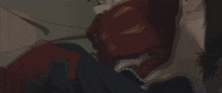 a close up of a person laying on the floor covering their face with their hand .