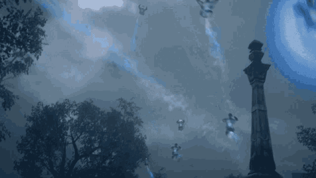 a statue in a cemetery with a blue light coming from it
