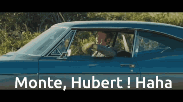 a man is driving a car with the words monte hubert haha written on the side