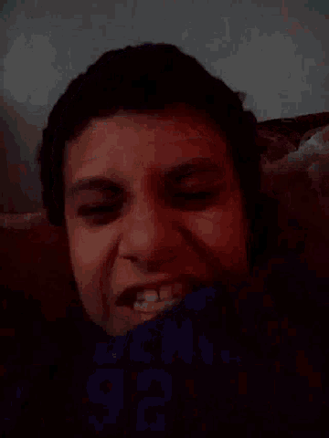 a close up of a person 's face with their mouth open