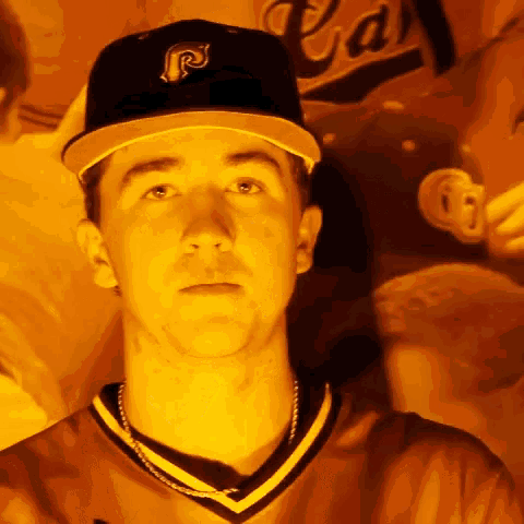 a young man wearing a hat with the letter p on it