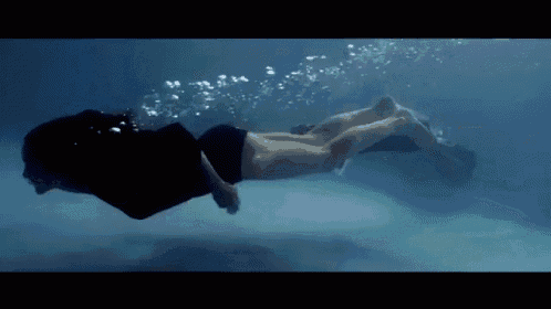 a man and a woman are swimming underwater