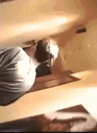 a man is doing a handstand in a room while wearing headphones .