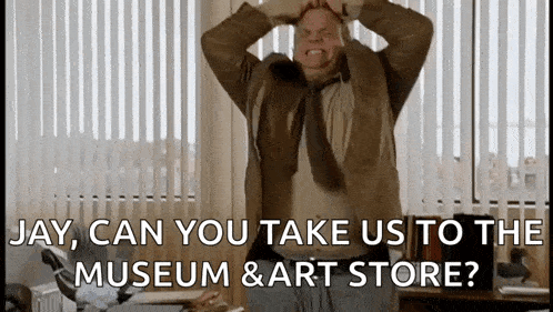 a man in a suit and tie is holding his head while talking about a museum and art store