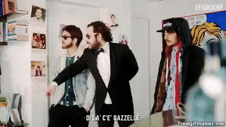 a man in a tuxedo says " dila c'e gazelle " in a room with two other men