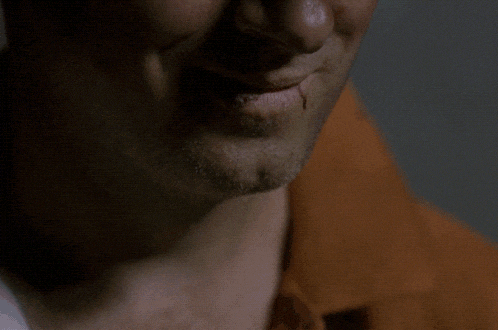 a close up of a man 's face with a slight smile on his face