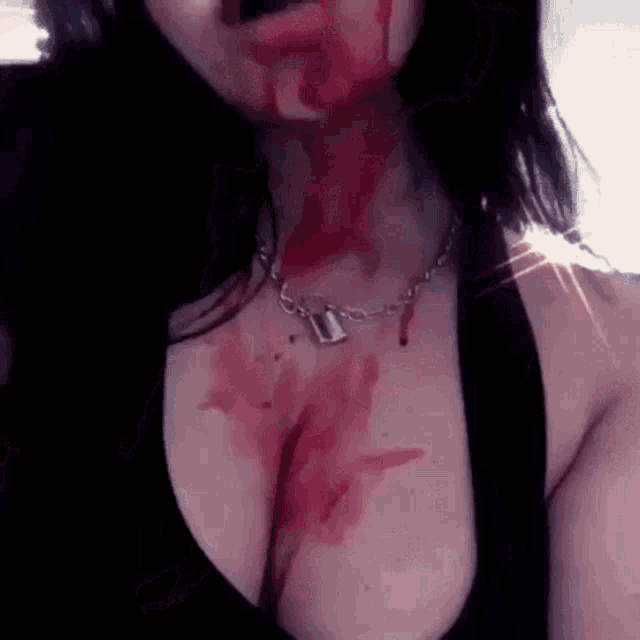 a woman with blood on her chest and face