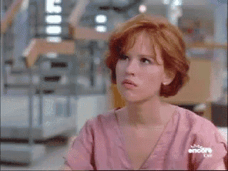 a woman with red hair is wearing a pink shirt that says encore on the sleeve
