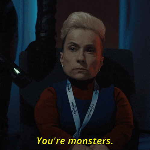 a woman with a lanyard that says you 're monsters on it