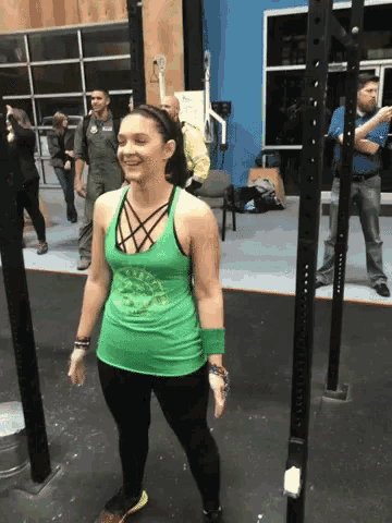 a woman wearing a green tank top that says rock on