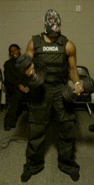 a man wearing a black vest that says donda on it