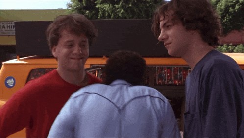 two men are standing next to each other and one has a sticker on his back that says ' yamaha '