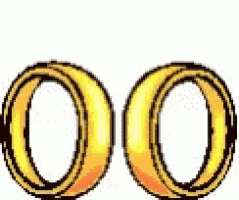 a pair of gold wedding rings with a red heart in the middle .