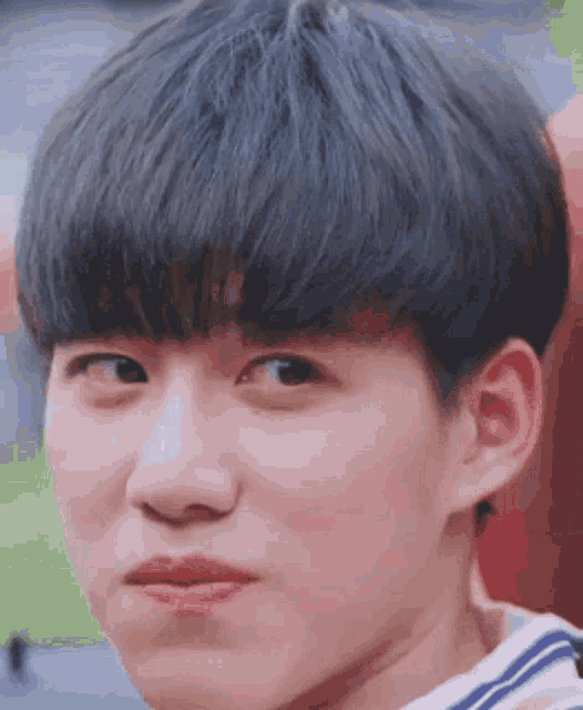 a close up of a young man 's face with a funny face .