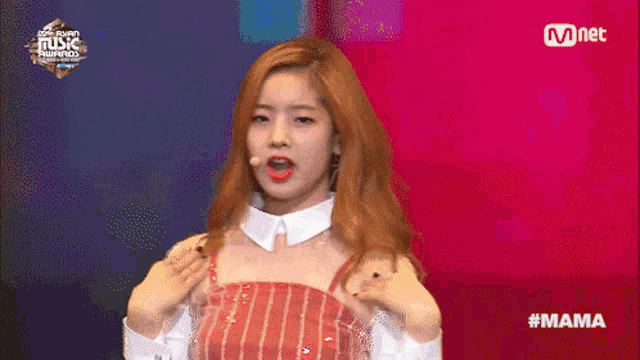 a woman performs on a stage at the mama music awards