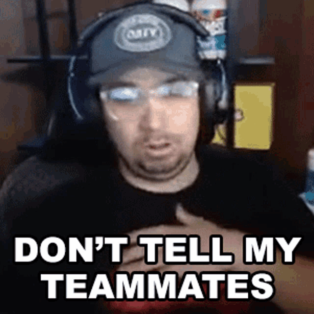 a man wearing headphones and a hat says " don t tell my teammates "
