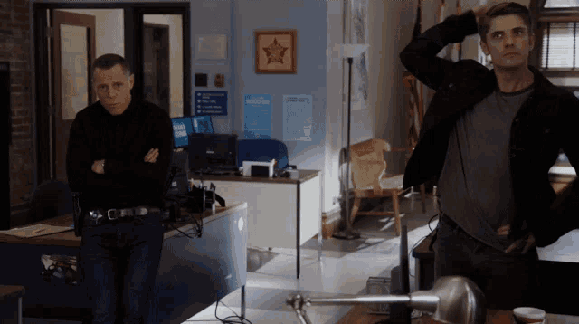 two men stand in a room with a sign that says welcome