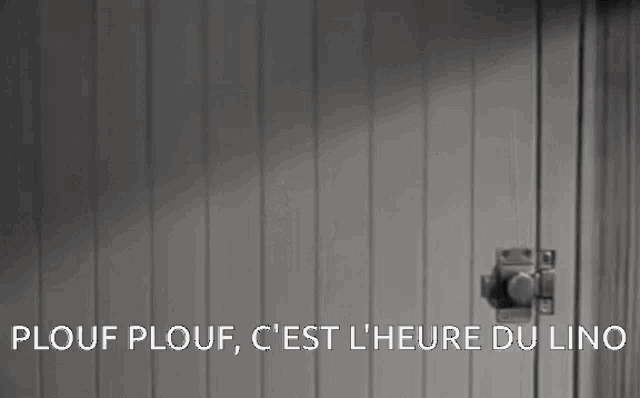 a black and white photo of a door with the words plouf plouf c'est l' heure du lino on the bottom