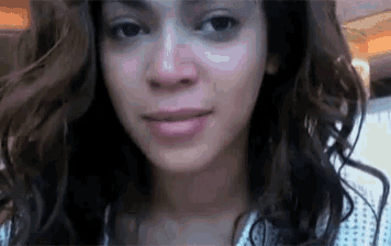 a close up of a woman 's face without makeup looking at the camera .