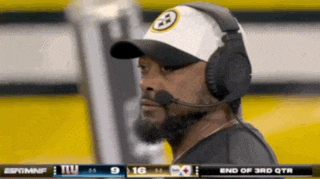 a man wearing a hat and headphones is watching a game