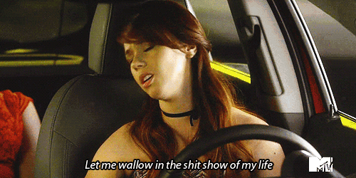 a woman sitting in a car with the words let me wallow in the shit show of my life below her