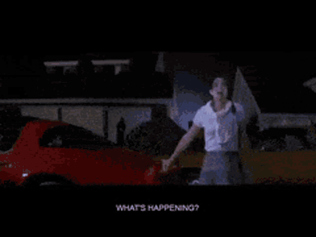 a woman standing in front of a red car with the words what 's happening on the screen