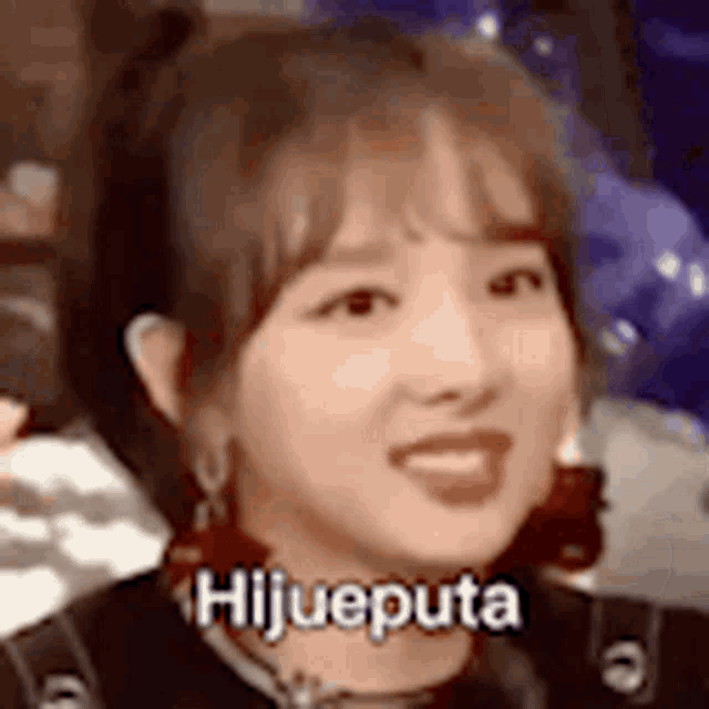 a close up of a woman 's face with the words `` hijueputa '' on it .