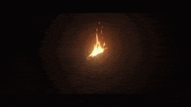 a circle of fire with sparks coming out of it in a dark room