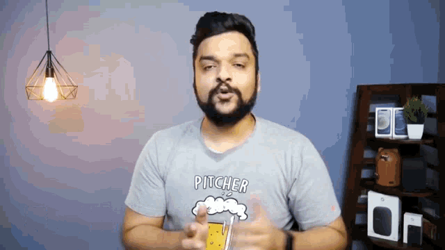 a man with a beard wearing a pitcher t-shirt